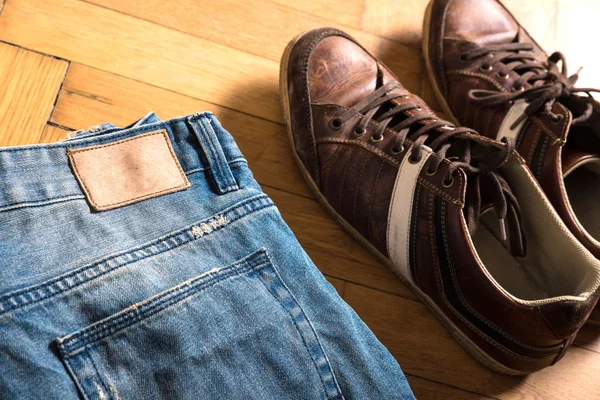 Shoes and jeans on the floor — Stock Photo, Image