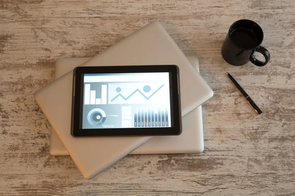 Business analytics met een tablet-pc en een gesloten laptops — Stockfoto