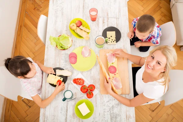 Happy family having breakfast at home — Stock Photo, Image