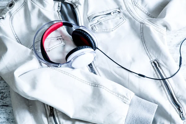 Fones de ouvido em um casaco branco — Fotografia de Stock