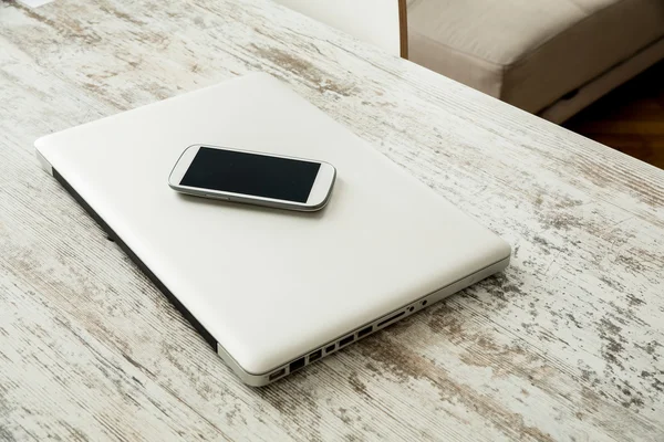 Smartphone and a laptop computer — Stock Photo, Image