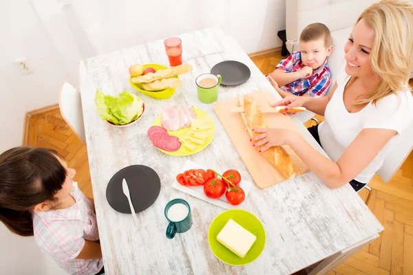 Happy family having breakfast at home — Stock Photo, Image