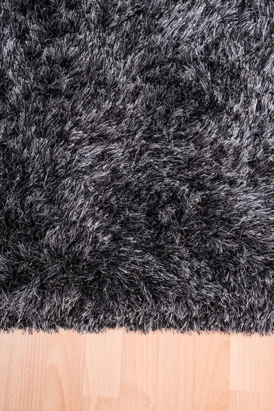 Fuzzy carpet lying on the floor — Stockfoto