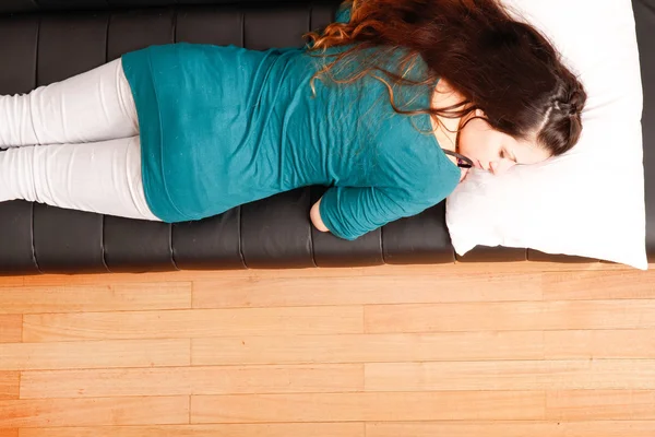 Young woman relaxing on sofa — Stock Photo, Image