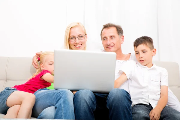 Happy family on the couch — Stock Photo, Image