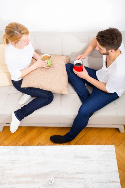 Young couple talking on the Sofa — Stock Photo, Image