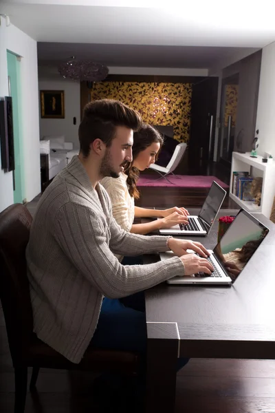 Dizüstü bilgisayarları evde genç Çift — Stok fotoğraf