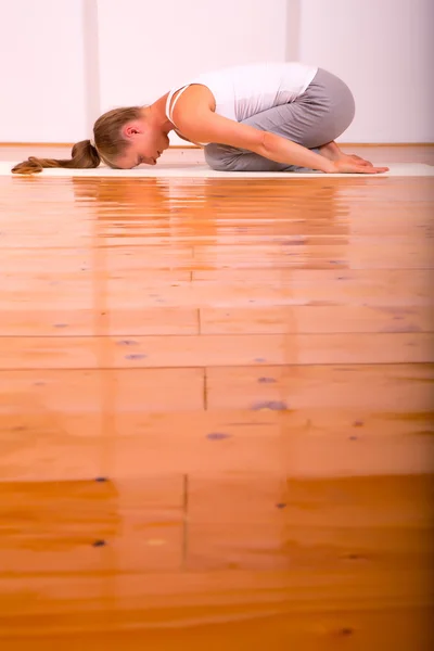 Woman practicing Yoga in a Studio Stock Image