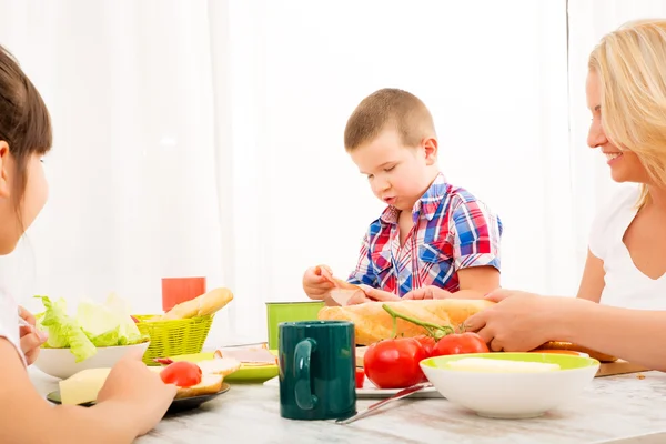 Happy family having breakfast at home — Stock Photo, Image
