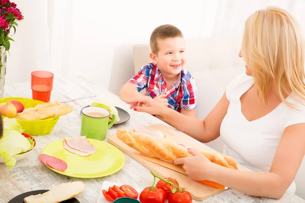 Happy family having breakfast at home — Stock Photo, Image