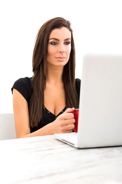 Young beautiful woman using a Laptop at home — Stock Photo, Image