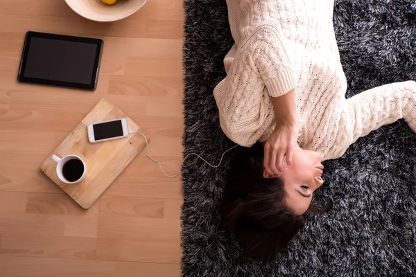 Young beautiful woman in underwear listening to music — Stock Photo, Image