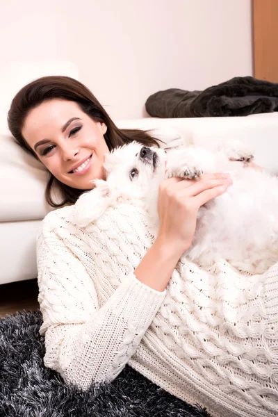 Young beautiful woman hugging her puppy — Stock Photo, Image