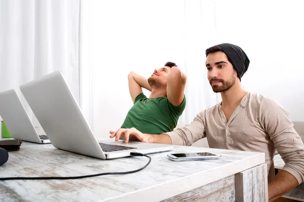 Two men working in their home office — Stock Photo, Image
