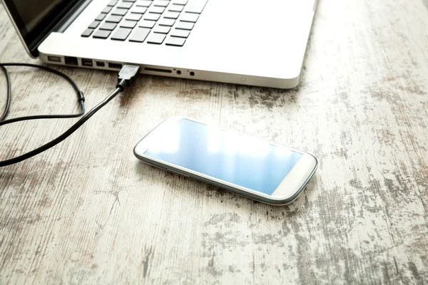 Smartphone and a Laptop computer on a Desktop — Stock Photo, Image