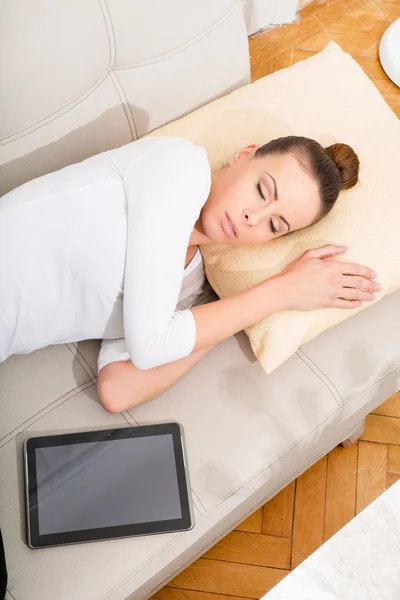 Young woman with a Tablet PC on the Sofa — Stock Photo, Image