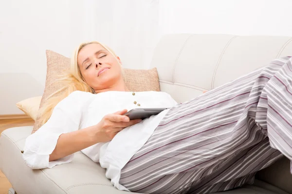 Woman sleeping with tablet on the sofa — Stock Photo, Image