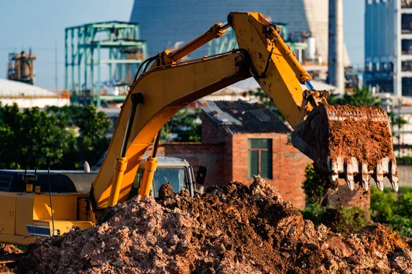 Grävmaskiner är uppdrag och raffinaderiet bakgrund — Stockfoto