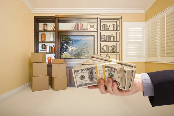 Holding Out Cash Over Drawing of Entertainment Unit In Room — Stock Photo, Image