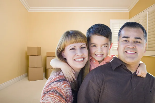 Familia de raza mixta joven en la habitación con cajas móviles —  Fotos de Stock