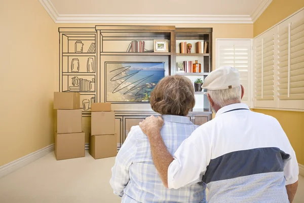 Senior paar kijken naar tekening van vermakelijkheid Unit op kamer — Stockfoto