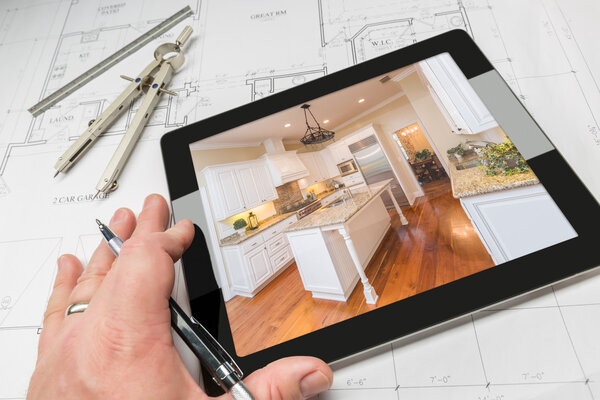 Hand of Architect on Computer Tablet Showing Home Illustration Over Plans