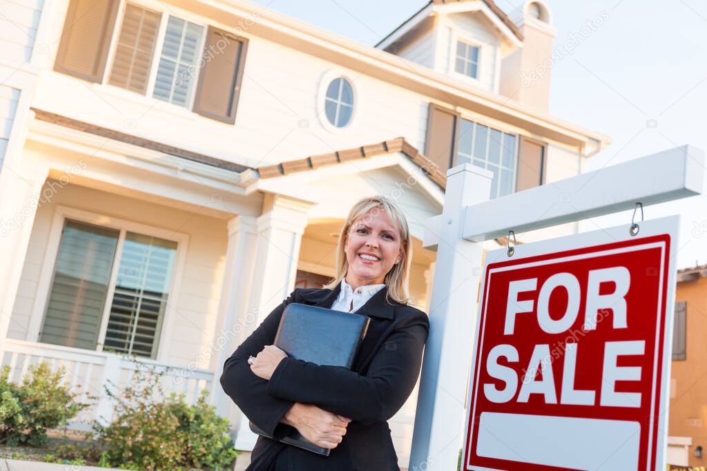 Female Real Estate Agent in Front of For Sale Sign and Beautiful House.