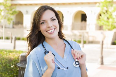 Proud Young Adult Woman Doctor or Nurse Portrait Outside clipart