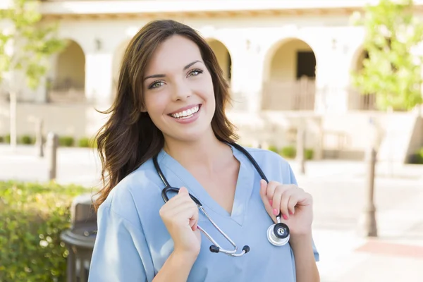 Orgullosa mujer adulta joven médico o enfermera retrato fuera — Foto de Stock