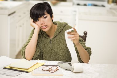 Multi-ethnic Young Woman Agonizing Over Financial Calculations clipart