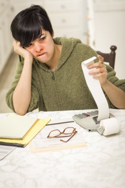 Multi-ethnic Young Woman Agonizing Over Financial Calculations clipart
