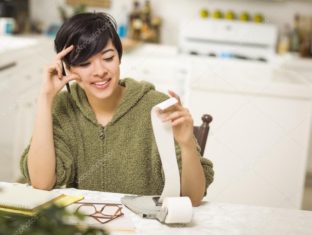 Multi-ethnic Young Woman Smiling Over Financial Calculations