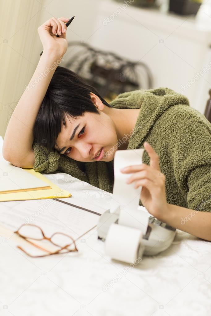 Multi-ethnic Young Woman Agonizing Over Financial Calculations