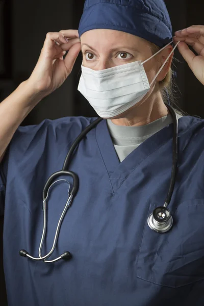 Female Doctor or Nurse Putting on Protective Face Mask — Stock Photo, Image