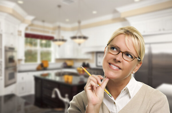 Daydreaming Woman with Pencil Inside Beautiful Custom Kitchen