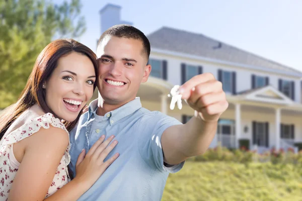 Military Couple with House Keys In Front of New Home Stock Image