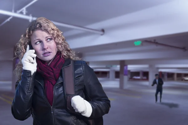 Frightened Young Woman On Cell Phone in Parking Structure — Stock Photo, Image