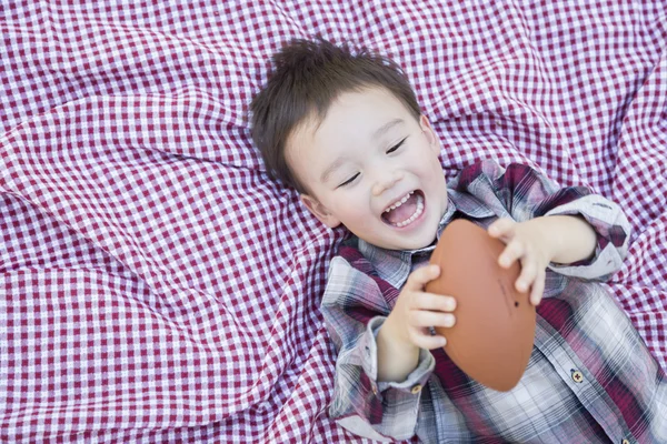 Young Mixed Race Boy Playing with Football on Picnic Blanket — Stock Photo, Image