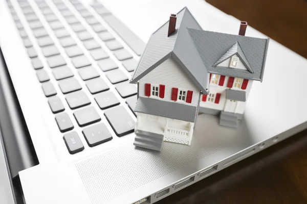 Miniature House on Laptop Computer Royalty Free Stock Photos