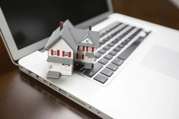 Miniature House on Laptop Computer Stock Picture