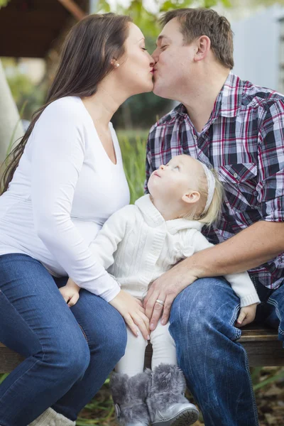 Happy Pregnant Couple Kisses as Baby Girl Watches — Stock Photo, Image