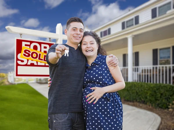 Hispanic Couple with Keys In Front of Home and Sign — Stock Photo, Image