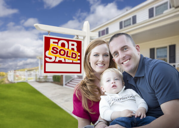 Young Military Family in Front of Sold Sign and House