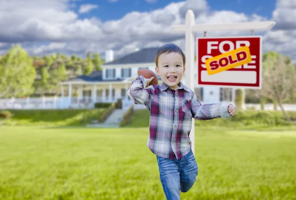 Boy Playing Ball in Yard Near Sold Real Estate Sign — Stock Photo, Image