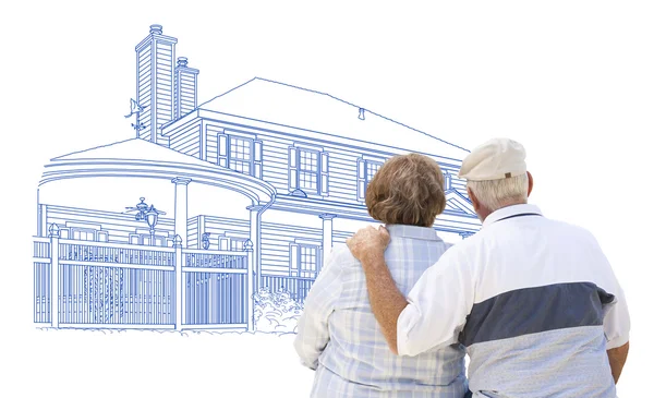 Embracing Senior par titta på hus ritning på vit — Stockfoto