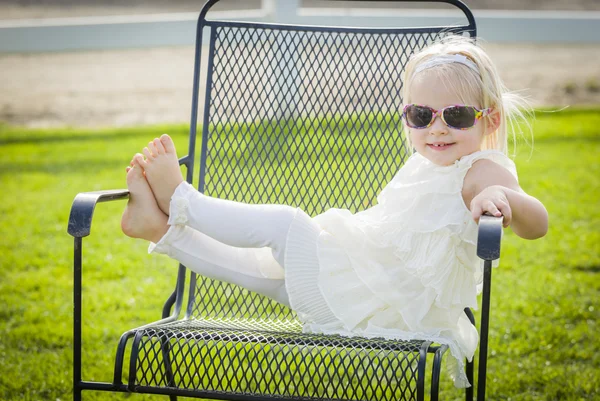 Mignon ludique bébé fille portant des lunettes de soleil à l'extérieur au parc — Photo