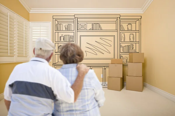 Senior paar In lege ruimte met plank tekening op de muur — Stockfoto