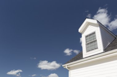 Roof of House and Windows Against Deep Blue Sky clipart