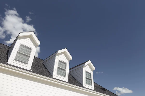 Roof of House and Windows Against Deep Blue Sky Royalty Free Stock Images