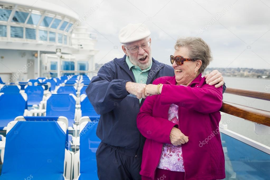 Senior Couple Fist Bump on Deck of Cruise Ship